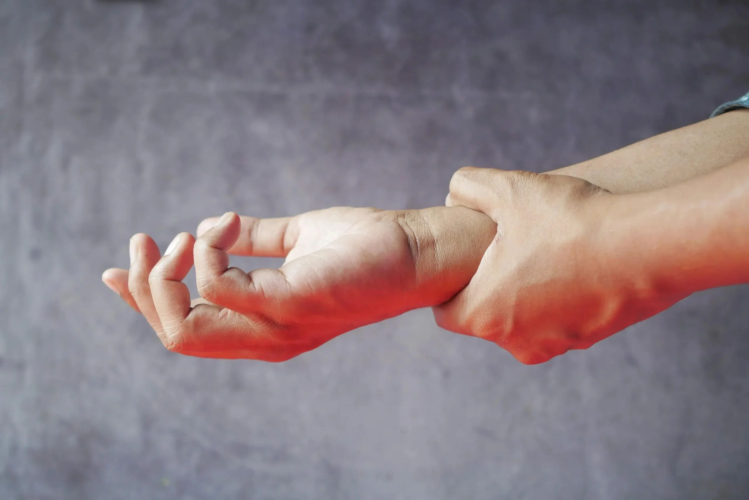 Person holding their wirst